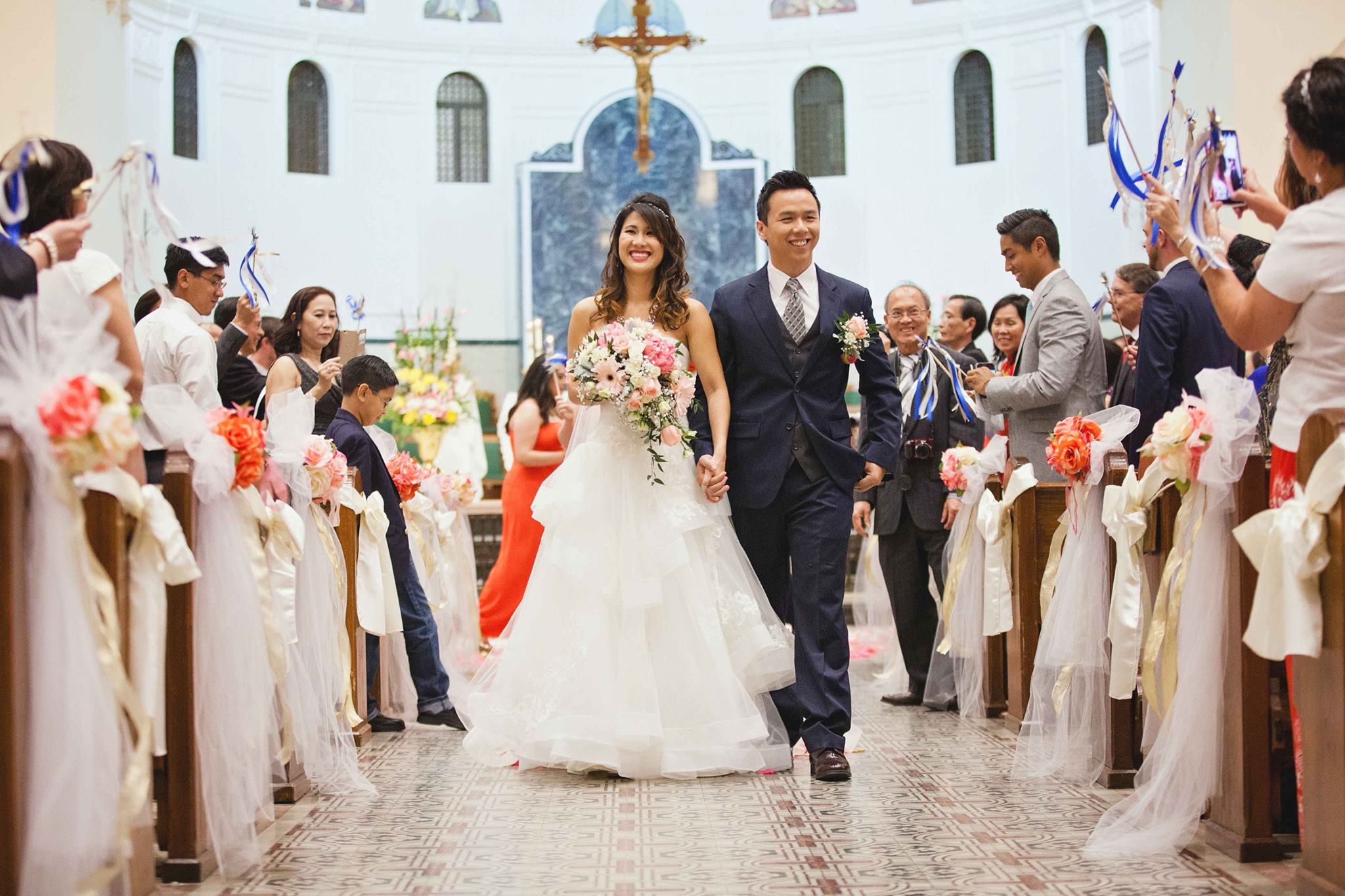 The married couple walking down the aisle